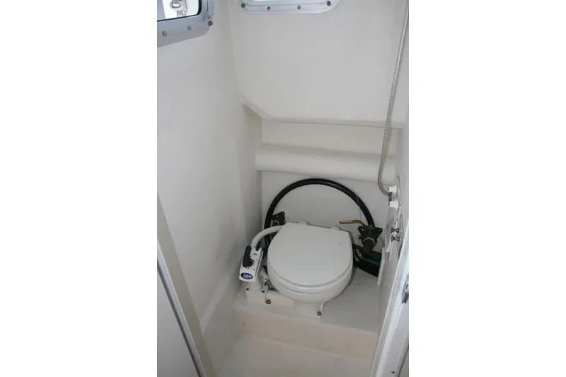Slide: The Image of 2003 SeaSport Explorer 2400 boat interior with compact marine toilet. - 15