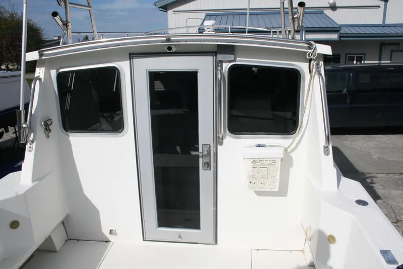 Slide: The Image of 2003 SeaSport Explorer 2400 boat stern view with cabin door and windows. - 3