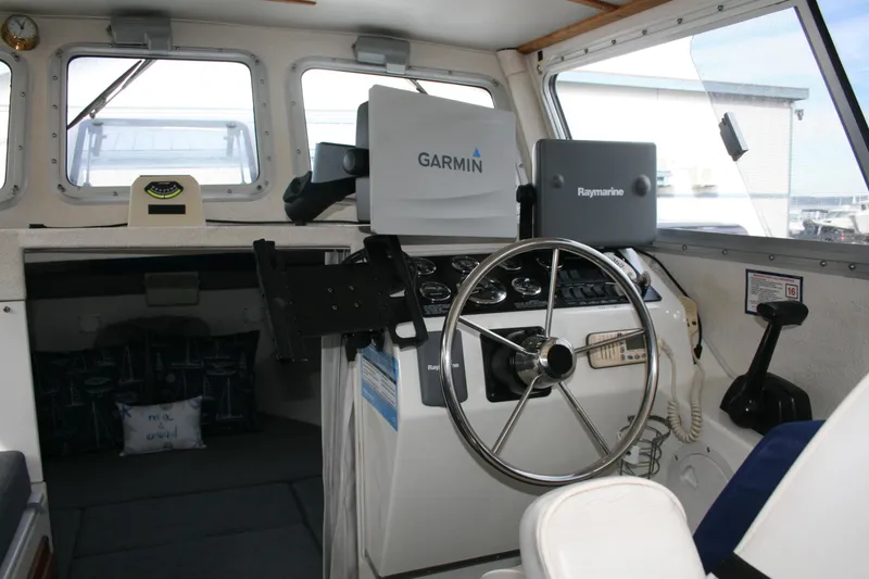 Slide: The Image of Interior of a 2003 SeaSport Explorer 2400 boat with Garmin and Raymarine equipment. - 5