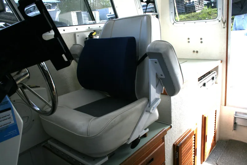 Slide: The Image of Interior of a 2003 SeaSport Explorer 2400 boat, featuring a captain's chair and steering wheel. - 7