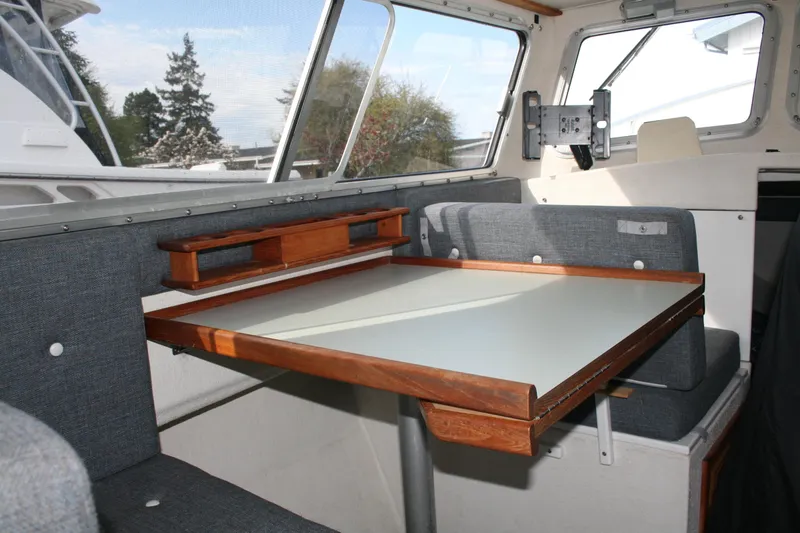 Slide: The Image of Interior of 2003 SeaSport Explorer 2400 with table and seating area. - 8