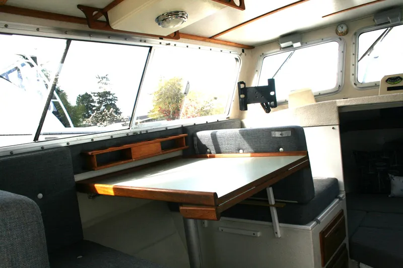 Slide: The Image of Interior of 2003 SeaSport Explorer 2400 boat with seating and table. - 9
