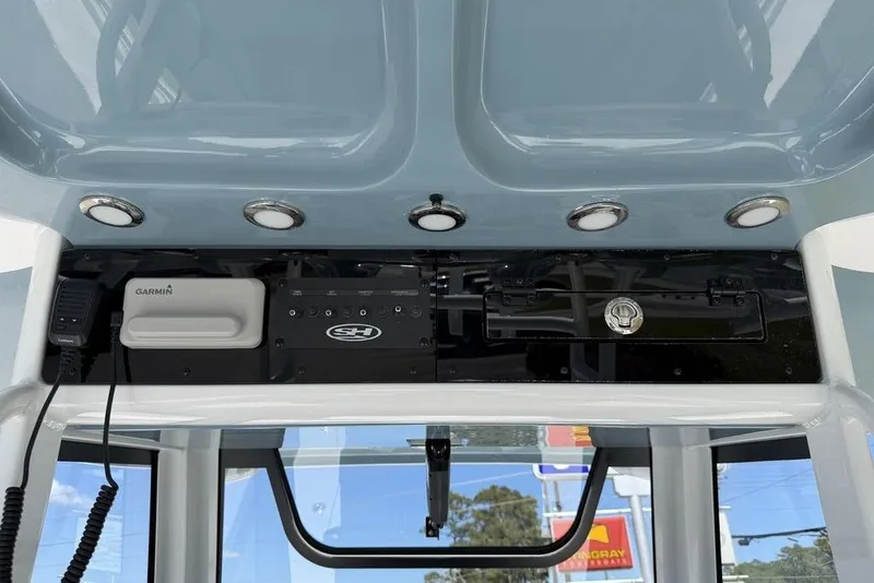 Slide: The Image of 2026 Sea Hunt Gamefish 30 Forward Seating boat interior with cushioned seats and storage compartments. - 12