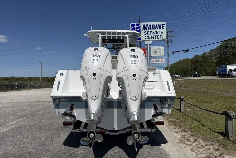Slide: The Image of 2026 Sea Hunt Gamefish 30 boat with forward seating and rod holders, viewed from below. - 13