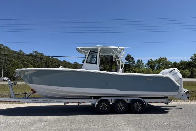 Slide: The Image of Helm of 2026 Sea Hunt Gamefish 30 with dual Garmin displays and steering wheel. - 19