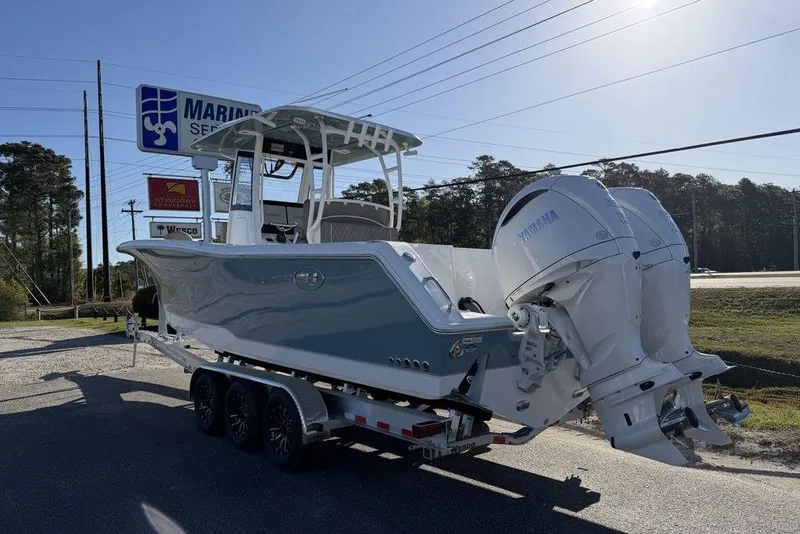 Slide: The Image of 2026 Sea Hunt Gamefish 30 boat on trailer with twin Yamaha engines. - 2
