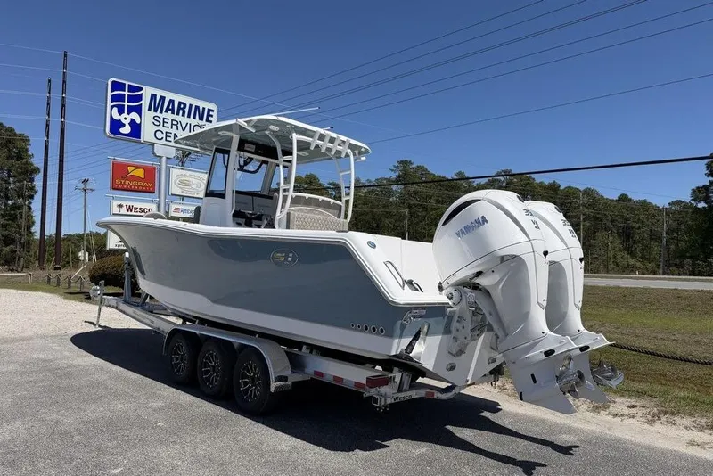 Slide: The Image of 2026 Sea Hunt Gamefish 30 boat on trailer, outdoor showroom background. - 20