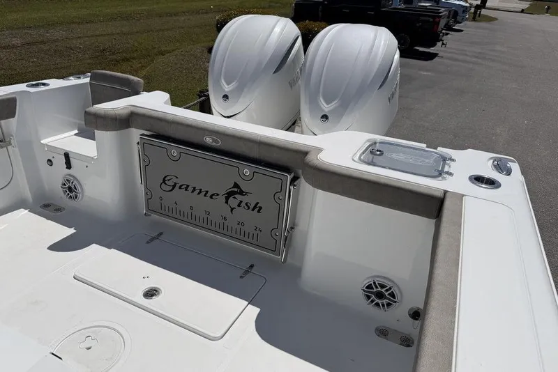 Slide: The Image of 2026 Sea Hunt Gamefish 30 Forward Seating boat on trailer, parked outdoors. - 3