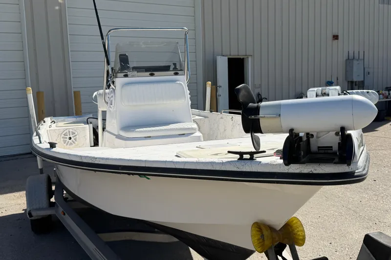 Slide: The Image of 2004 Kenner 1800 VISION boat on trailer, parked outside a building. - 10