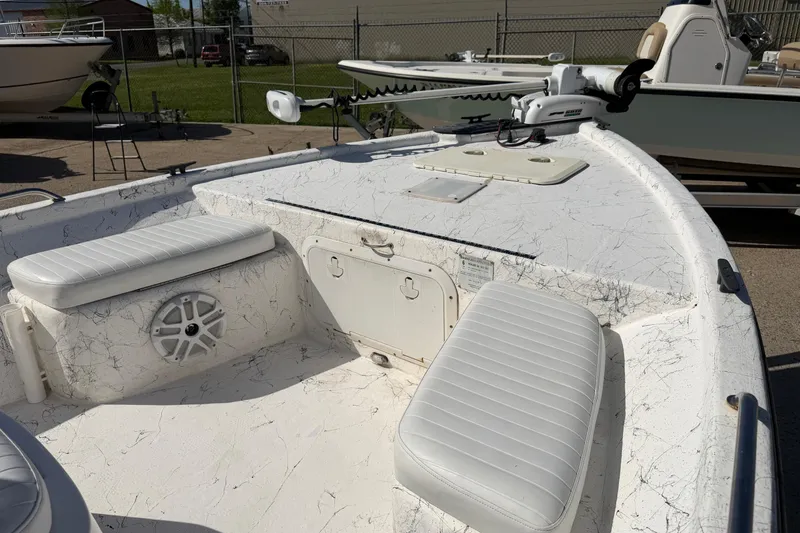 Slide: The Image of 2004 Kenner 1800 VISION boat interior with white seating and storage compartments. - 12