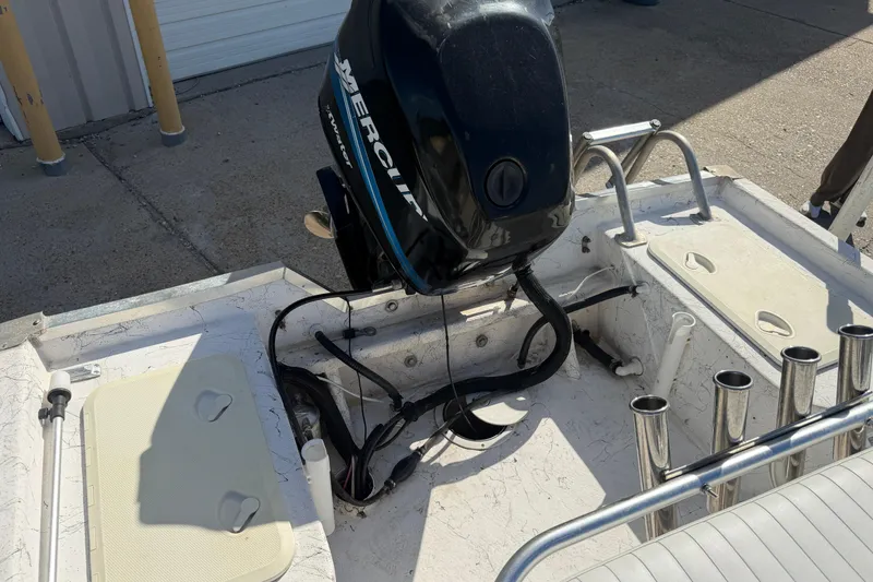 Slide: The Image of 2004 Kenner 1800 VISION boat with Mercury outboard motor, docked on concrete surface. - 19