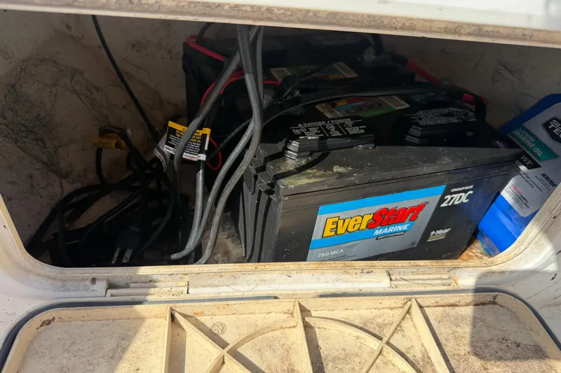 Slide: The Image of Marine battery compartment in a 2004 Kenner 1800 VISION boat, featuring EverStart battery. - 24