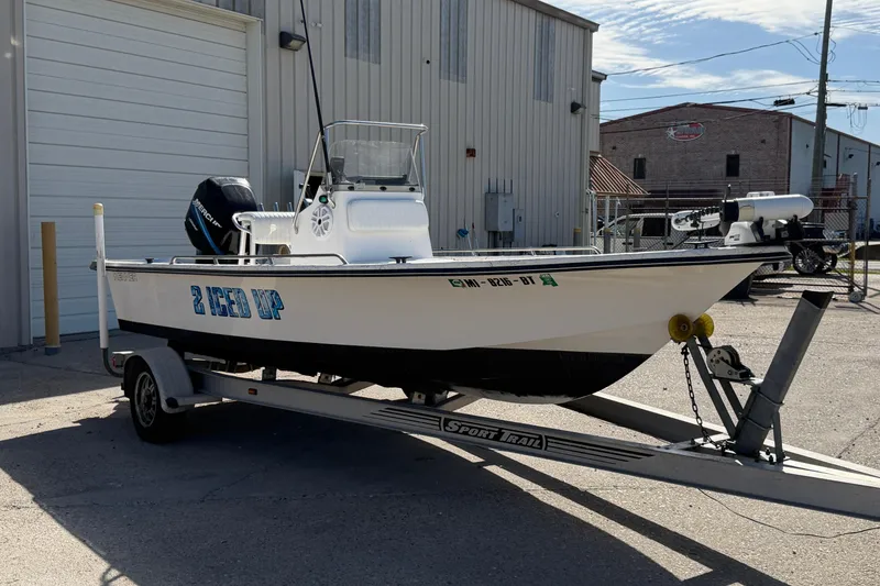 Slide: The Image of 2004 Kenner 1800 VISION boat on trailer, parked outside industrial building. - 9