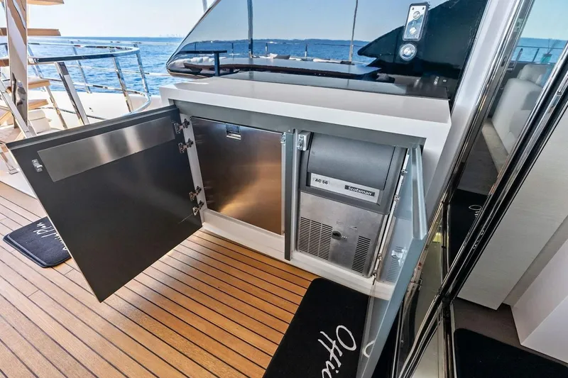 Slide: The Image of Luxury yacht Navetta 33, 2022 model, featuring an open cabinet with a built-in ice maker. - 31