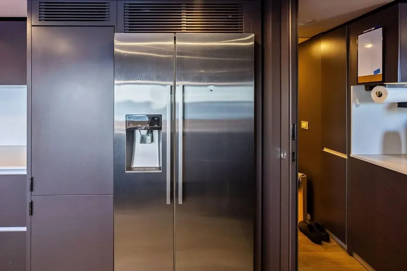 Slide: The Image of Modern kitchen with stainless steel refrigerator on Custom Line Navetta 33 yacht, 2022 model. - 71