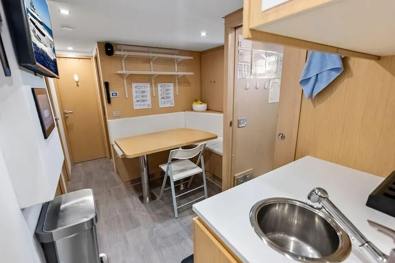 Slide: The Image of Interior of 2022 Custom Line Navetta 33 yacht with kitchenette and dining area. - 92