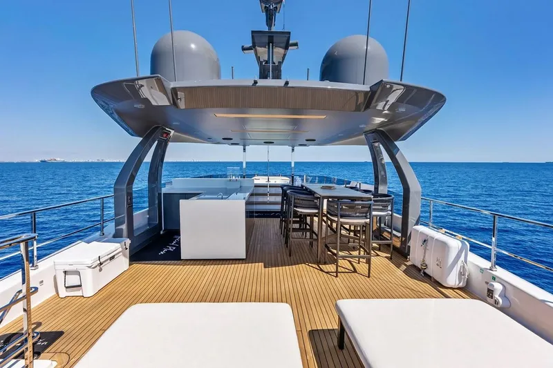 Slide: The Image of Luxurious 2022 Custom Line Navetta 33 yacht deck with seating, overlooking the ocean. - 14