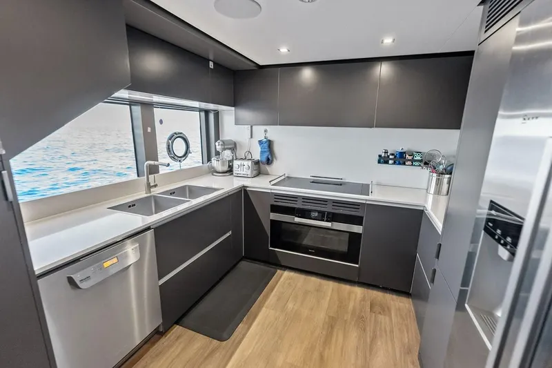 Slide: The Image of Modern kitchen interior on 2022 Custom Line Navetta 33 yacht, featuring sleek appliances and ocean view. - 69
