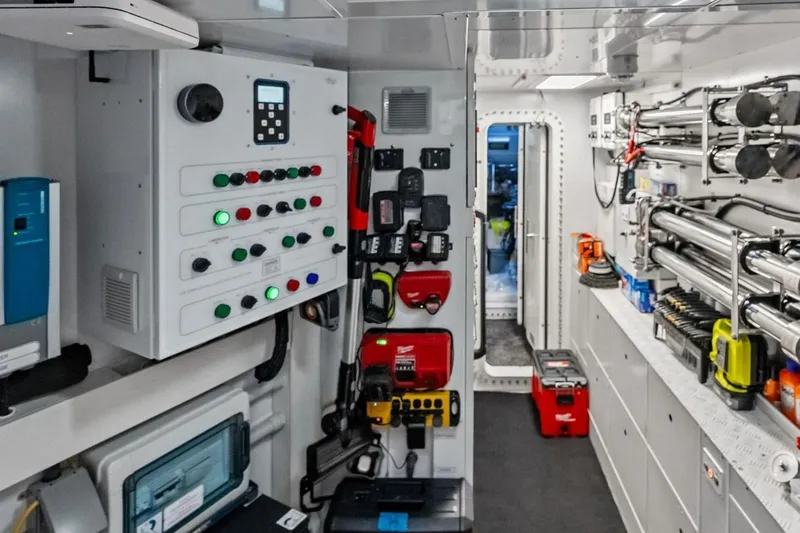 Slide: The Image of Interior of 2022 Custom Line Navetta 33 yacht, featuring control panels and equipment storage. - 97