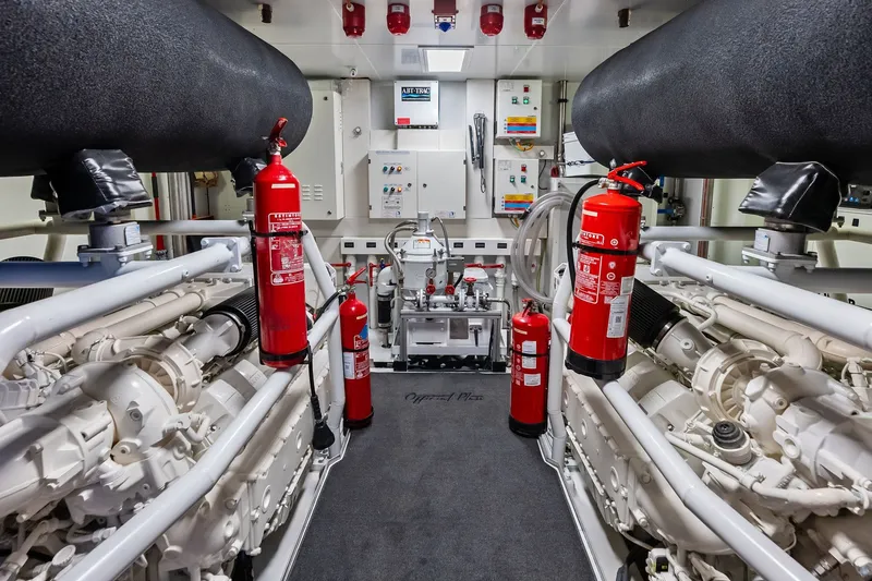 Slide: The Image of Engine room of 2022 Custom Line Navetta 33 yacht with fire extinguishers and machinery. - 106