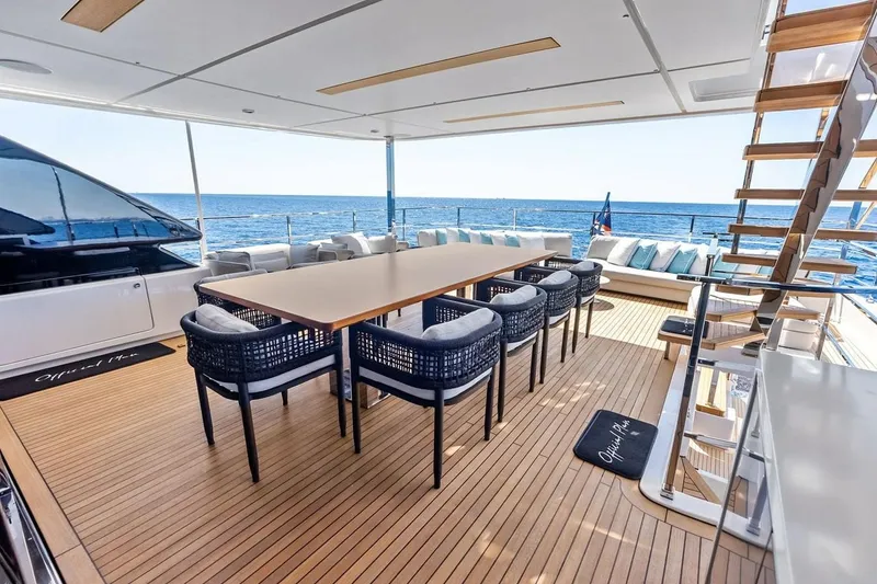 Slide: The Image of Luxurious 2022 Custom Line Navetta 33 yacht deck with dining area and ocean view. - 25