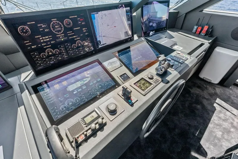 Slide: The Image of Cockpit of 2022 Custom Line Navetta 33 yacht with advanced navigation displays and controls. - 54