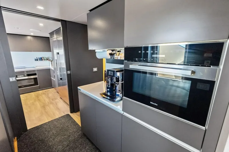 Slide: The Image of Modern kitchen interior on Custom Line Navetta 33 yacht, featuring sleek appliances and cabinetry, 2022 model. - 67