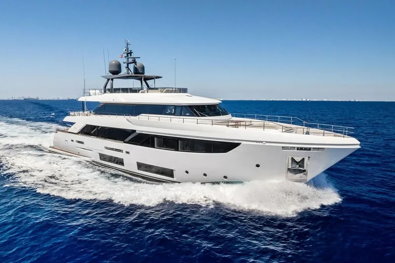 The Image of Luxurious 2022 Custom Line Navetta 33 yacht cruising on open sea under clear blue sky. - 1