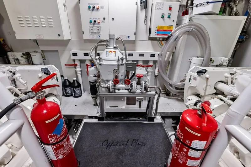 Slide: The Image of Engine room of 2022 Custom Line Navetta 33 yacht with fire extinguishers and control panels. - 95