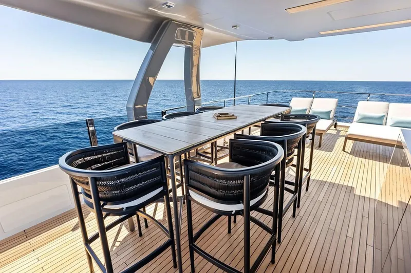 Slide: The Image of Luxurious 2022 Custom Line Navetta 33 yacht deck with elegant seating and ocean view. - 24