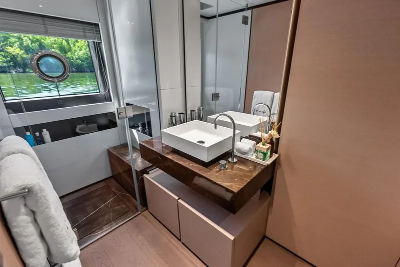 Slide: The Image of Luxurious bathroom on 2022 Custom Line Navetta 33 yacht with modern sink and scenic window view. - 82