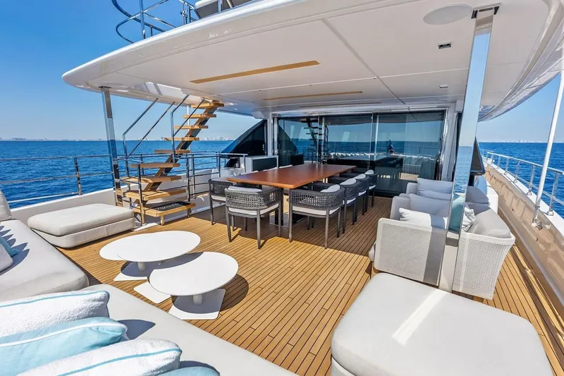 Slide: The Image of Luxurious 2022 Custom Line Navetta 33 yacht deck with seating, dining area, and ocean view. - 28