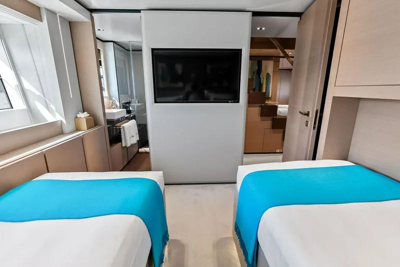 Slide: The Image of Luxurious 2022 Custom Line Navetta 33 yacht bedroom with twin beds and modern decor. - 90
