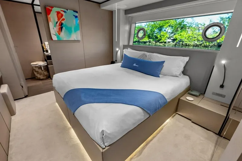 Slide: The Image of Luxurious bedroom interior on 2022 Custom Line Navetta 33 yacht, featuring modern decor and large window. - 83