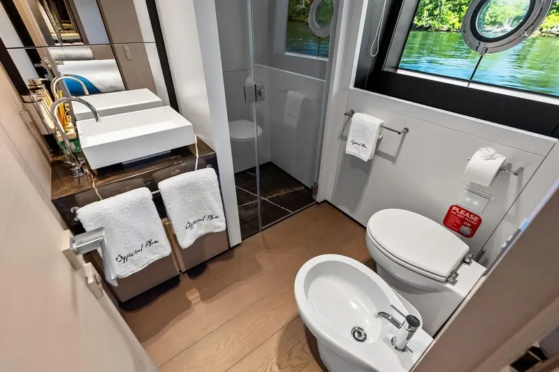 Slide: The Image of Luxurious bathroom on 2022 Custom Line Navetta 33 yacht with modern fixtures and scenic window view. - 88