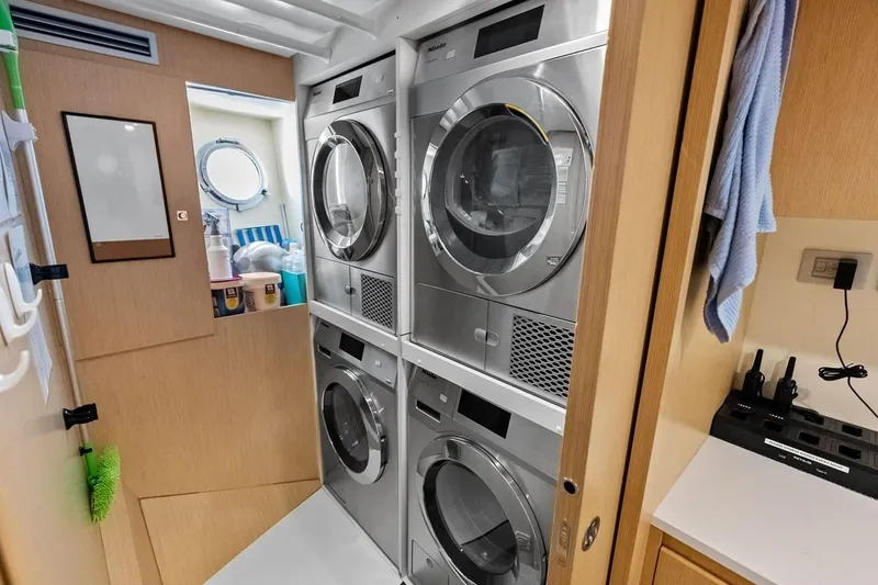 Slide: The Image of Laundry room with stacked washers and dryers on a 2022 Custom Line Navetta 33 yacht. - 94