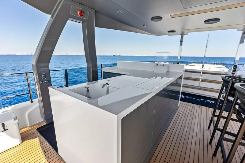 Slide: The Image of Luxurious 2022 Custom Line Navetta 33 yacht deck with modern bar and ocean view. - 20