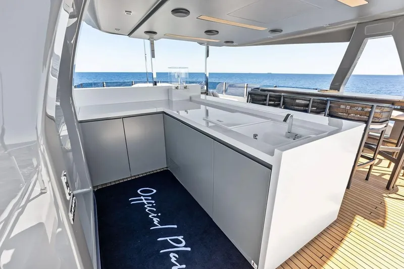 Slide: The Image of Luxurious outdoor kitchen on 2022 Custom Line Navetta 33 yacht, featuring sleek countertops and ocean view. - 21