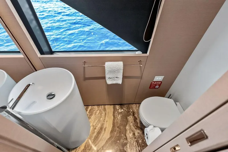 Slide: The Image of Luxurious bathroom on Custom Line Navetta 33 yacht, featuring ocean view and elegant fixtures. - 49