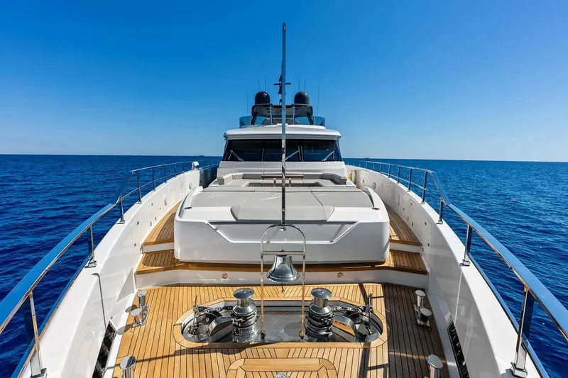 Slide: The Image of Luxurious 2022 Custom Line Navetta 33 yacht cruising on open sea under clear blue sky. - 32