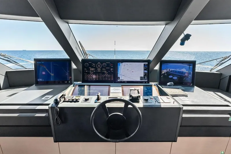 Slide: The Image of Cockpit of 2022 Custom Line Navetta 33 yacht with navigation screens and steering wheel. - 51