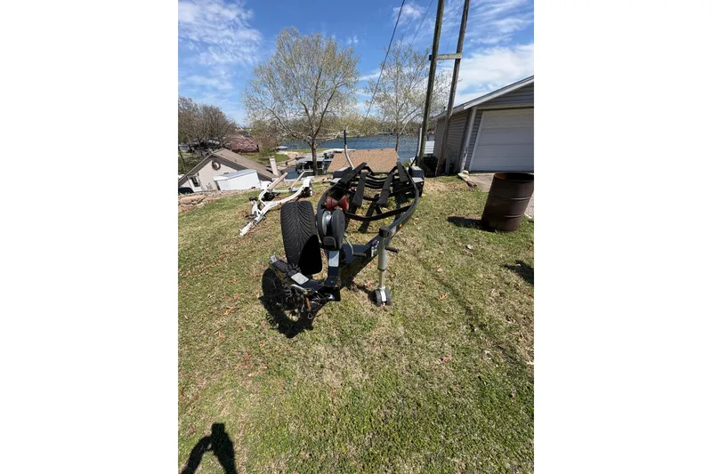 Slide: The Image of 2011 Malibu Wakesetter 247 LSV trailer on grassy yard near lake and garage. - 17