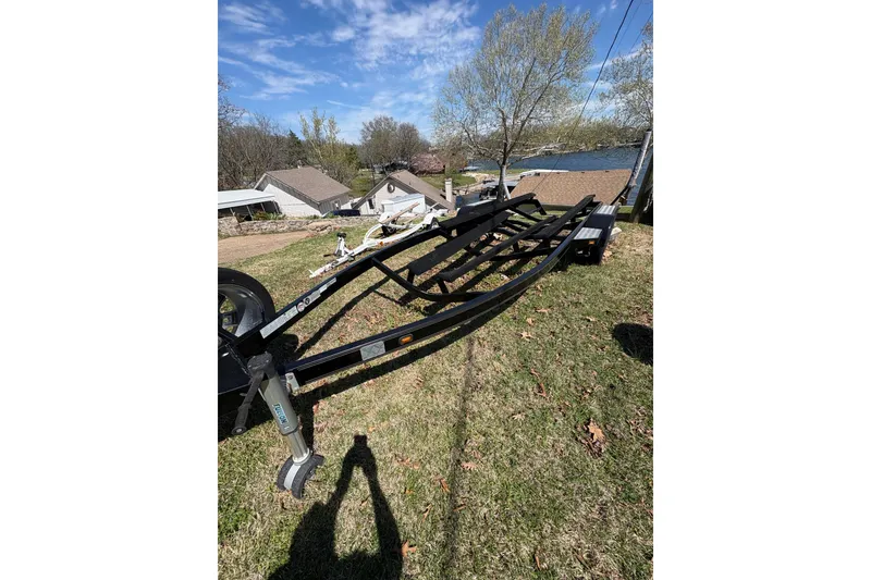 Slide: The Image of Trailer for 2011 Malibu Wakesetter 247 LSV on grassy area near lake. - 18