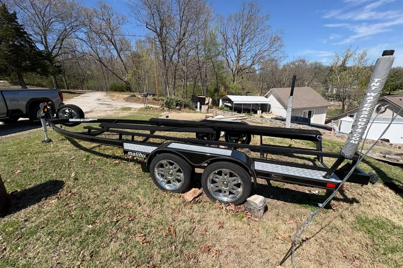 Slide: The Image of Trailer for 2011 Malibu Wakesetter 247 LSV on grassy area, surrounded by trees. - 19