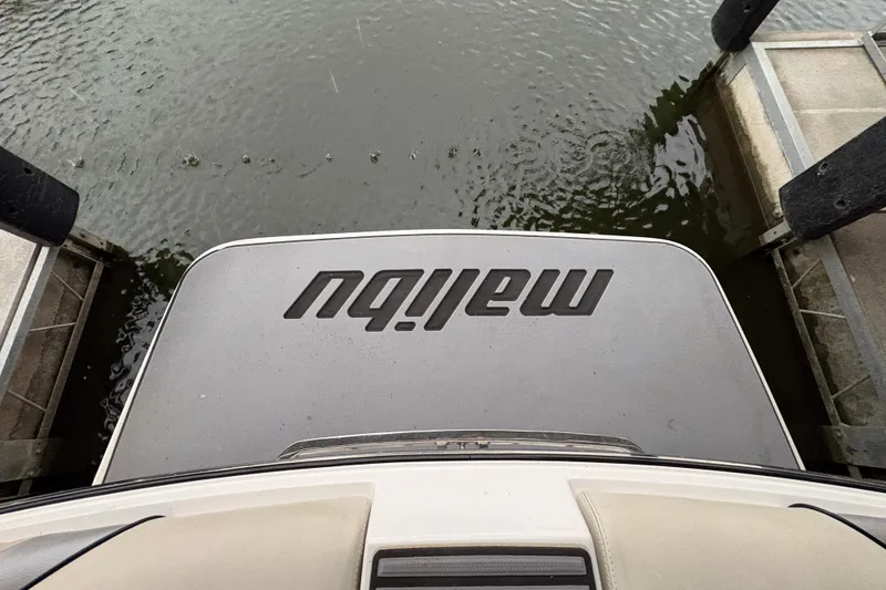 Slide: The Image of 2011 Malibu Wakesetter 247 LSV boat docked on calm water. - 28