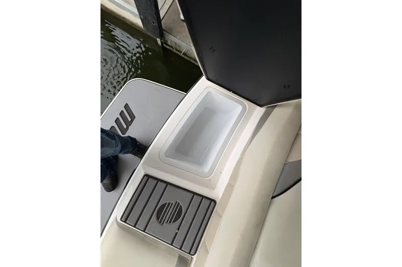 Slide: The Image of 2011 Malibu Wakesetter 247 LSV boat interior with storage compartment and seating. - 30
