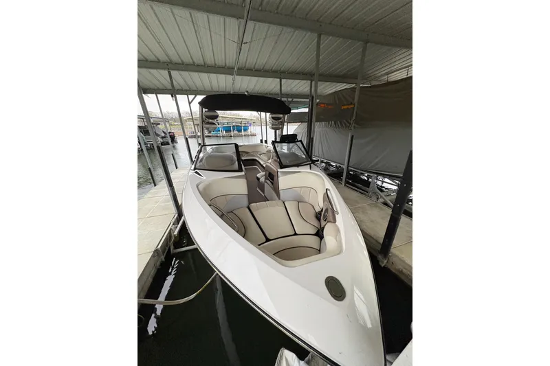 Slide: The Image of 2011 Malibu Wakesetter 247 LSV boat docked under a covered slip. - 32