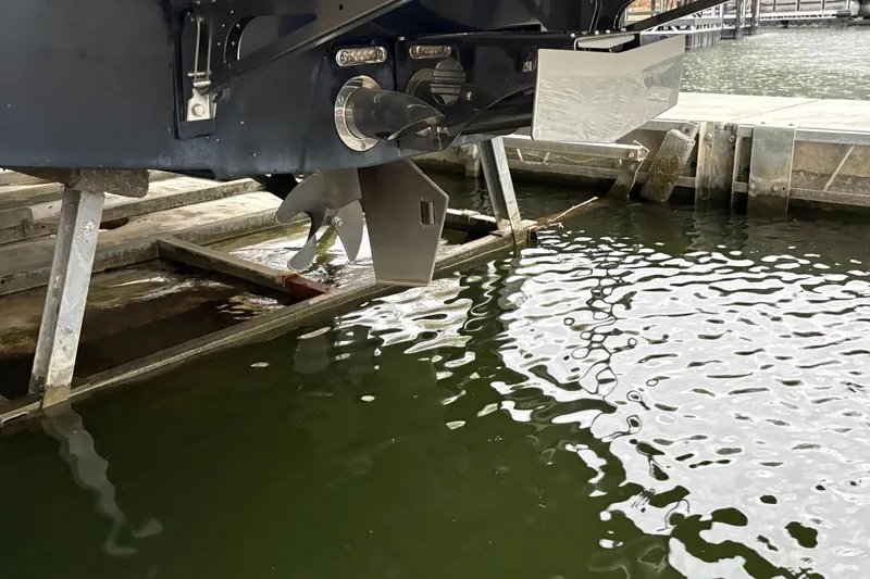 Slide: The Image of 2011 Malibu Wakesetter 247 LSV propeller and rudder near dock. - 34