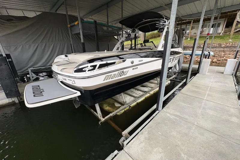 Slide: The Image of 2011 Malibu Wakesetter 247 LSV boat docked in covered marina. - 4