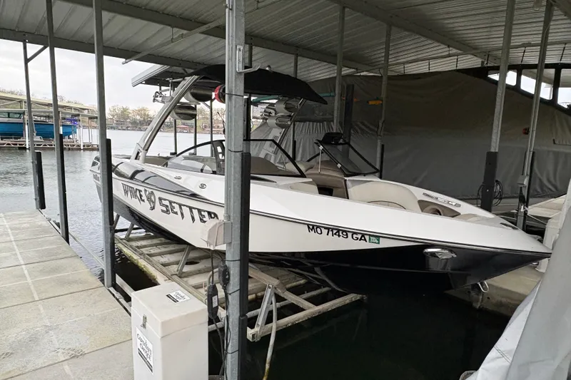 Slide: The Image of 2011 Malibu Wakesetter 247 LSV boat docked in covered marina. - 5